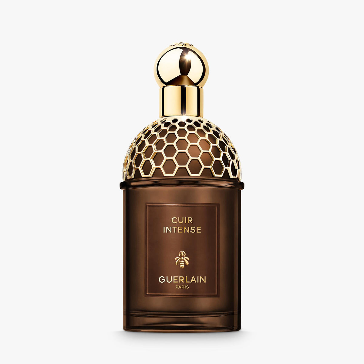 Guerlain perfume bottle with gold cap on a white background