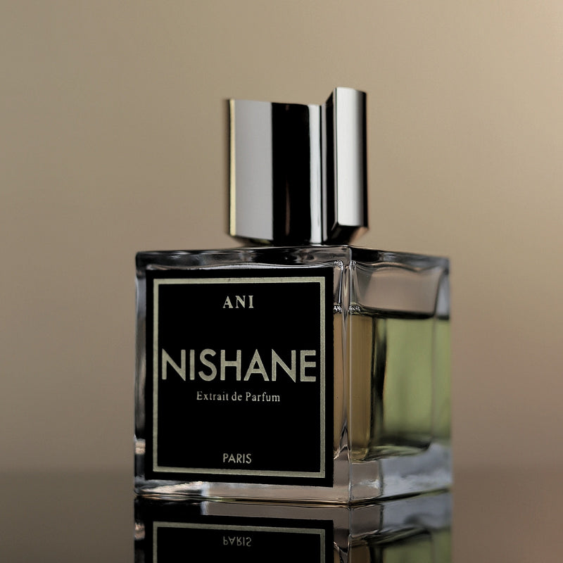 Nishane perfume bottle with a black label on a beige background