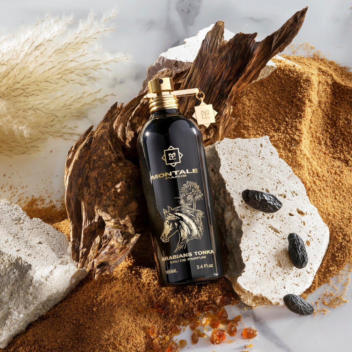 Montale perfume bottle with desert elements on a textured surface
