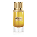 Chopard perfume bottle with gold cap on a green background