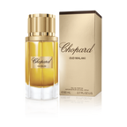 Chopard Oud Malaki perfume bottle and packaging on a green background