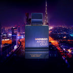 Haramain Amber Oud perfume bottle with Dubai skyline in the background