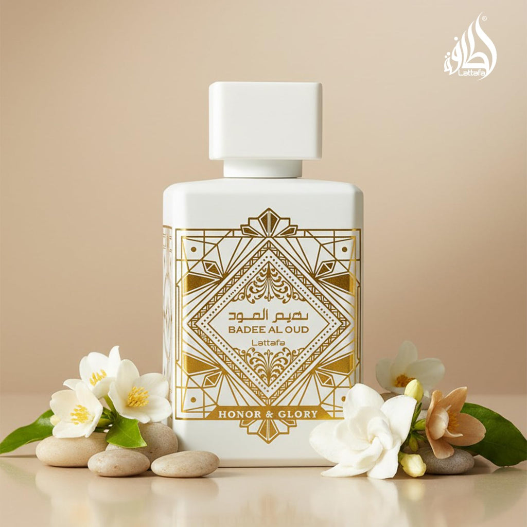 Perfume bottle Lattafa Bade’e Al Oud Honour & Glory with decorative label surrounded by flowers on a beige background