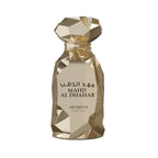 Mahd Al Dhahab Arabiyat Prestige Gold perfume bottle with geometric design on a white background