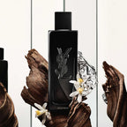 Black YSL perfume bottle with decorative elements on a white background